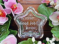 「永年勤続者の名前、会社名、サムアップのイラスト」を彫刻した、永年勤続の表彰記念品用のガラス製小物入れ