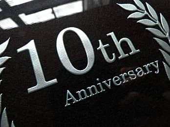 彫刻部をシルバーに着色加工した周年祝い用のガラス盾のクローズアップ画像