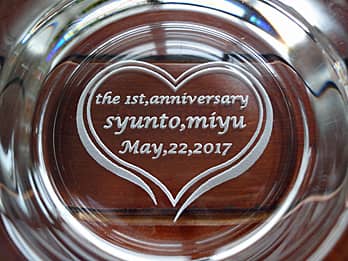 「The 1st anniversary、旦那様と奥さまの名前」を底面に彫刻した、結婚記念日のプレゼント用のガラス製灰皿