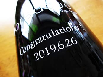 ボトル側面の彫刻部を、シルバーに着色加工した周年祝い用のワインの画像
