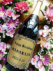「Happy Birthday、贈る相手の名前、誕生日の日付」をボトル側面に彫刻した誕生日プレゼント用のシャンパン