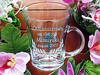 「10th anniversary on the job、永年勤続者の名前、日付」を彫刻した、永年勤続表彰の記念品用のガラス製ティーカップ