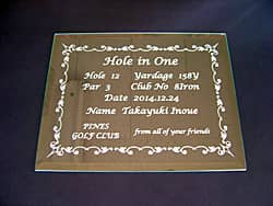 「Hole in one、達成日、達成者名」を彫刻した、ホールインワンの記念品用のガラス盾