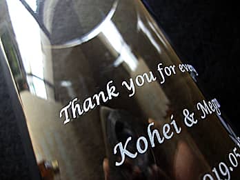 両親へ贈呈するグラス側面に彫刻した、「感謝を込めたメッセージ、新郎と新婦の名前」のクローズアップ画像
