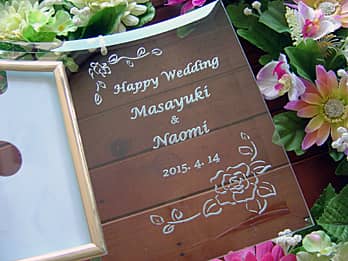 「お祝いメッセージ、新郎と新婦の名前、結婚式の日付」を彫刻した、結婚祝い用のガラス製写真立て