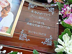 「米寿おめでとう ○○姉ちゃん、日付」を彫刻した、姉への米寿祝い用のガラス製写真立て